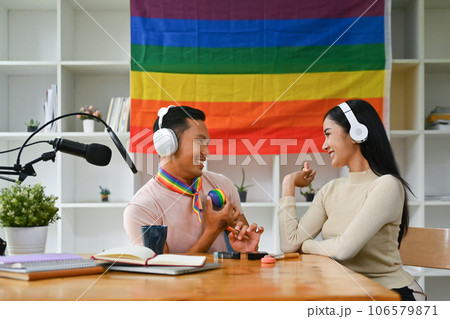 Positive gay male podcaster and his female friend, recording conversation for channel LGBT, friendship and lifestyle concept Positive gay male podcaster and his female friend, recording conversation for channel LGBT, friendship and lifestyle concept 106579871