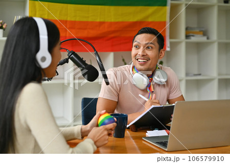 Positive gay male podcaster and his female friend, recording conversation for channel LGBT, friendship and lifestyle concept 106579910