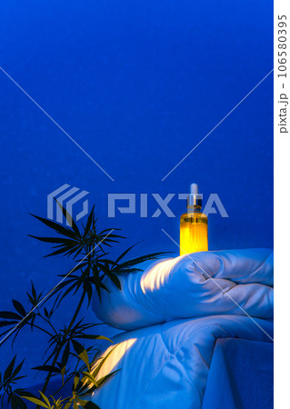 Night bedroom with moonlight, CBD oil tincture on a blanket podium, hemp branch Night bedroom with moonlight, CBD oil tincture on a blanket podium, hemp branch 106580395