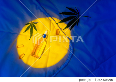 Night bedroom, a bottle of cannabis oil, cannabis branch in moonlight Night bedroom, a bottle of cannabis oil, cannabis branch in moonlight 106580396