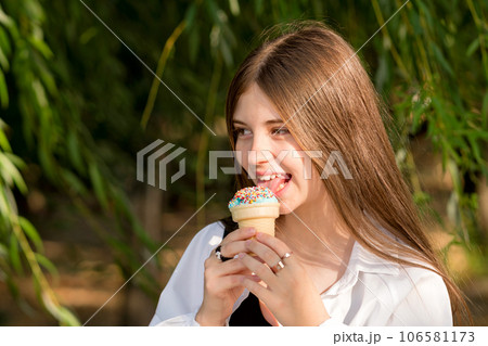 Teenage girl eat ice cream on walk Teenage girl eat ice cream on walk 106581173