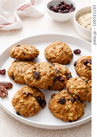 Oatmeal cranberry healthy homemade cookies with cinnamon and pecan nuts for breakfast Oatmeal cranberry healthy homemade cookies with cinnamon and pecan nuts for breakfast 106581285