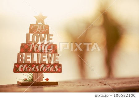 Wooden christmas tree toy on the beach 106582100