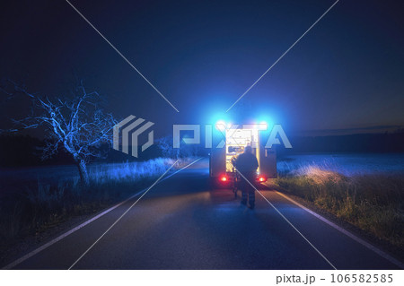 Paramedic in blurred motion is pulling stretcher with patient to ambulance car Paramedic in blurred motion is pulling stretcher with patient to ambulance car 106582585