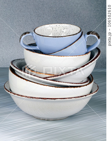 Ceramic bowls and cups are stacked on top of each other. Ceramic bowls and cups are stacked on top of each other. 106582610