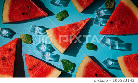 Creative summer composition with watermelon, mint leaves, can of soda and ice cubes. Minimal watermelon drink concept. Creative summer composition with watermelon, mint leaves, can of soda and ice cubes. Minimal watermelon drink concept. 106583142