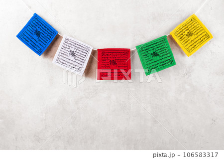 Colorful Tibetan buddhist prayer flags by Nepal on a grey background, copy space 106583317