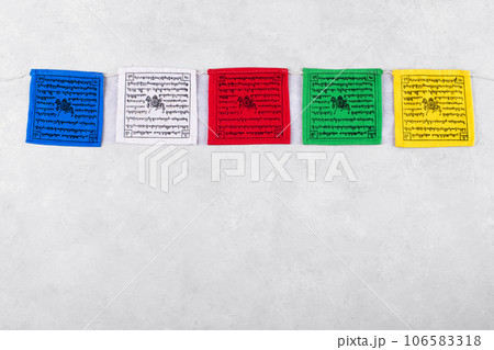 Colorful Tibetan buddhist prayer flags by Nepal on a grey background, copy space 106583318