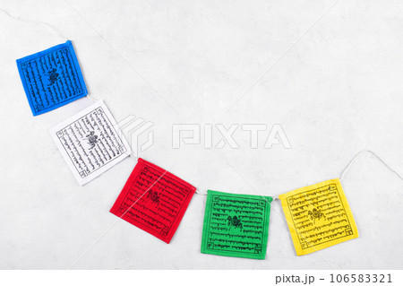 Colorful Tibetan buddhist prayer flags by Nepal on a grey background, copy space 106583321