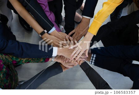 Team, teamwork, and unity concept. Diverse team putting hands together. Group of diverse business people. Working together as a team. Partnership and togetherness create a strong sense of community. 106583357