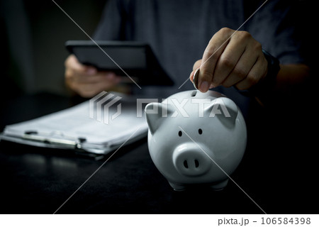 piggy bank with coins and currency, concept of saving money.Business financial planning, investment, budgeting, and money management. 106584398