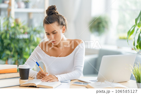 woman working on laptop at home woman working on laptop at home 106585127
