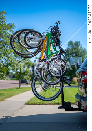 vertical mounted bikes on a vehicle carrier attached to a trailer hitch.  106585176
