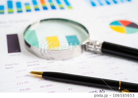 Magnifying glass on graph paper. Financial development, Banking Account, Statistics, Investment Analytic research data economy, Business concept. Magnifying glass on graph paper. Financial development, Banking Account, Statistics, Investment Analytic research data economy, Business concept. 106585653