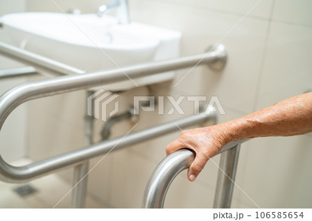 Asian elderly woman patient use toilet bathroom handle security in nursing hospital, healthy strong medical concept. Asian elderly woman patient use toilet bathroom handle security in nursing hospital, healthy strong medical concept. 106585654