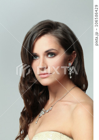 Pretty woman with fresh clear shiny skin, wavy dark hair and makeup Pretty woman with fresh clear shiny skin, wavy dark hair and makeup 106586429