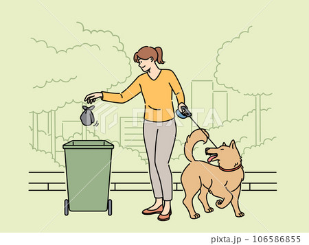 Woman walking dog throws bag of puppy poop into trash can, taking care of cleanliness of park 106586855