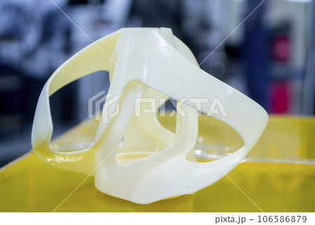 Printed models on 3D printer close-up. Objects printed on photopolymer sla 3D printer from liquid photopolymer resins on printing platform inside 3d printer. Modern progressive additive technology. 106586879