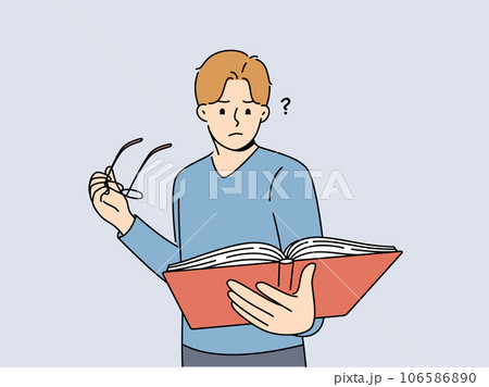 Man with book takes off glasses, getting upset because of deterioration of vision 106586890
