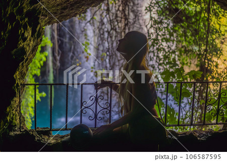 Beautiful woman with long hair on the background of Duden waterfall in Antalya. Famous places of Turkey. Apper Duden Falls 106587595