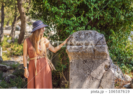 Woman tourist explores Stunning Ancient Theater of Termessos Ancient City turkiye, GO Everywhere Woman tourist explores Stunning Ancient Theater of Termessos Ancient City turkiye, GO Everywhere 106587619