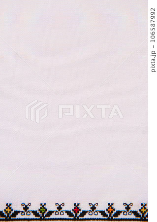 Texture of linen textile with embroidery. Ethnic pattern design. Craft embroidery Geometric ornament 106587992