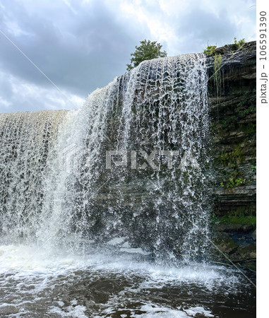 A beautiful big waterfall in Estonia on a clear sunny day 106591390