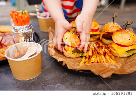 french fries and Mini burgers for a children's party or picnic.  106591893