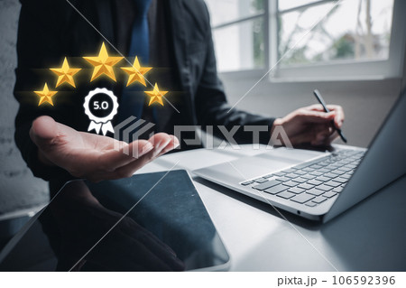 Close-up shot of a client's hand holding up five stars, rating the quality of service provided. Satisfaction guaranteed. Customer service and Satisfaction concept Close-up shot of a client's hand holding up five stars, rating the quality of service provided. Satisfaction guaranteed. Customer service and Satisfaction concept 106592396