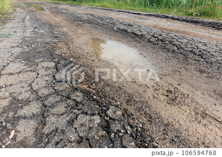 old broken road with cracked asphalt old broken road with cracked asphalt 106594768