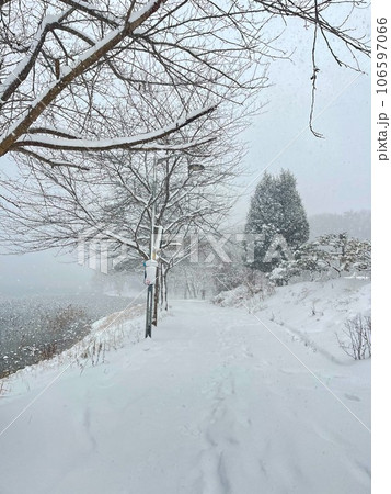 snow covered road in winter 106597066