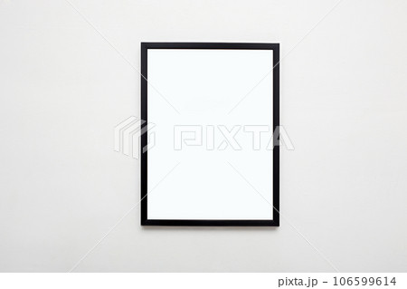 black picture frame on white wall. Stylish modern photoframe 106599614