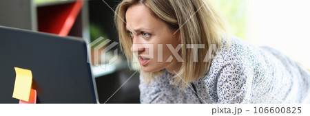 Confused and upset woman looking at computer screen 106600825
