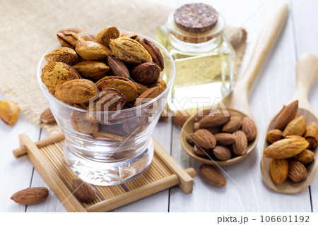Almonds in a black bowl against dark rustic wooden background Almonds in a black bowl against dark rustic wooden background 106601192