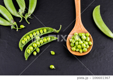 Sugar snap peas with mint on a rustic wood background Sugar snap peas with mint on a rustic wood background 106601367