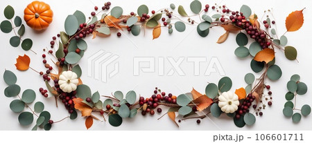 Thanksgiving day or Halloween concept banner. Top view white background decor from pumpkin, red berry, green leaves with copy space. autumn and fall season background. 106601711