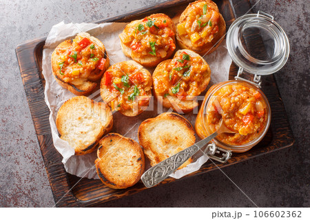 Spicy appetizer dip of eggplant, tomatoes, onions, bell peppers and garlic closeup. Horizontal top view 106602362