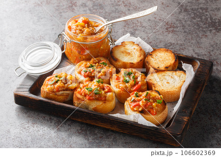 Sandwiches with homemade spread from eggplant, zucchini, tomatoes, onions, bell peppers. Horizontal 106602369