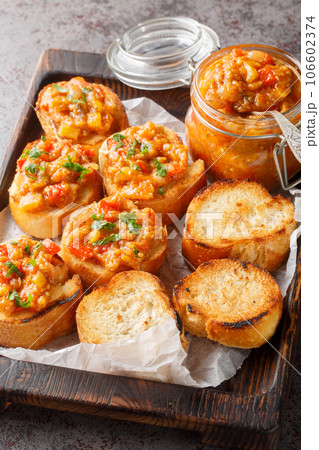 Bread toasts with eggplant caviar closeup on the wooden board. Vertical Bread toasts with eggplant caviar closeup on the wooden board. Vertical 106602374