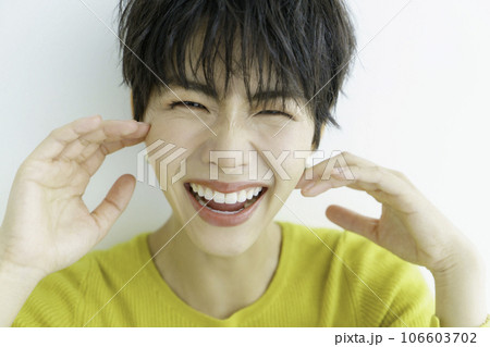 白背景の黄色い服を着た若い女性のポートレート 白背景の黄色い服を着た若い女性のポートレート 106603702