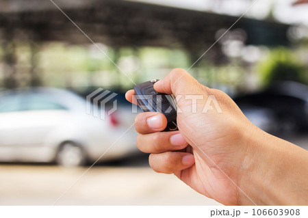 Close up hand holding car key Close up hand holding car key 106603908
