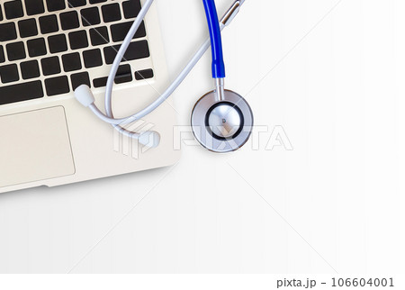 Blue medical stethoscope and laptop computer on white background 106604001
