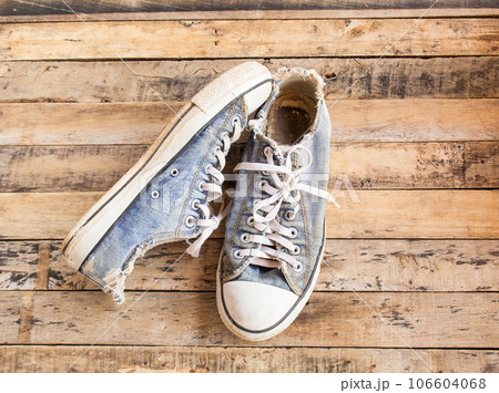 Old shoes on wooden floor 106604068