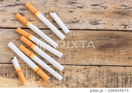 Cigarette roll on old wooden table 106604073