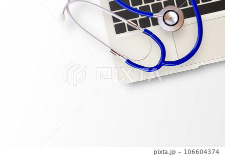Medical stethoscope and laptop computer on white 106604374