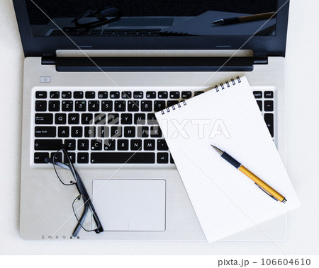Laptop, notepad and glasses 106604610