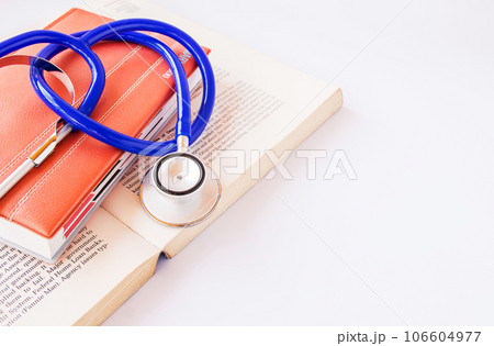 Stethoscope on a pile of books 106604977