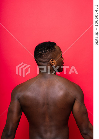 A handsome and muscular young man posing in the studio. 106605431