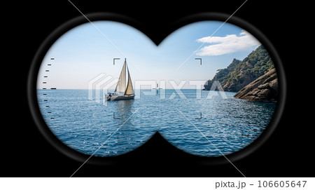 Binoculars Point of View with a Sailing Boat in the Blue Sea 106605647