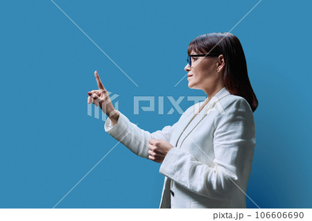 Business woman touching with finger on virtual screen, blue background 106606690